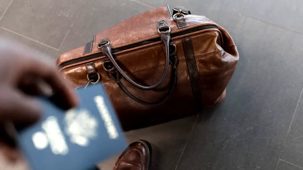 Does a Purse Count As a Carry-on or Personal Item | a traveler standing with passport and personal item